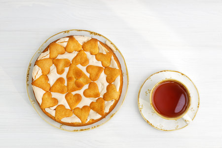 Homemade berry pie with meringue and cookies on white wooden table. Top view.