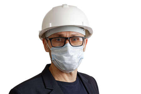 Portrait of a man in suit, a white construction helmet and medical mask, isolated on white.の写真素材
