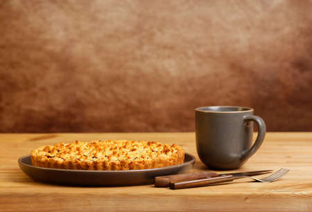 Homemade cherry pie and cup of tea on wooden table. Front view. Copyspace.の写真素材