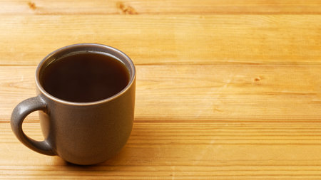 Mug of tea on wooden table. Copyspace.の写真素材