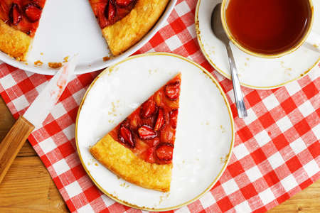 Closeup piece of gallet with strawberries and rhubarb on table. Top view.の写真素材
