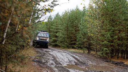 Ulyanovsk, Russia - September 25, 2021. Rally raid "Hills of Russia". Rally car truck KAMAZ on a dirt road through the forest.のeditorial素材