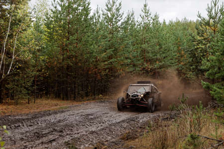 Ulyanovsk, Russia - September 25, 2021. Rally raid "Hills of Russia". Rally car buggy on a dirt road through the forest.のeditorial素材