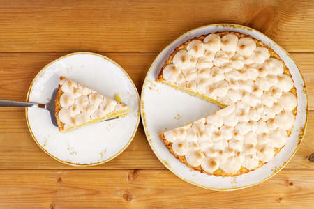 Homemade pie decorated with meringue on a wooden table. Top view.の写真素材