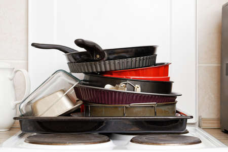 Set of cookware and pans stacked together on kitchen stoveの写真素材