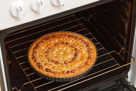 Closeup homemade pie with nuts hazelnut baked in a home oven. Shallow focus.の写真素材