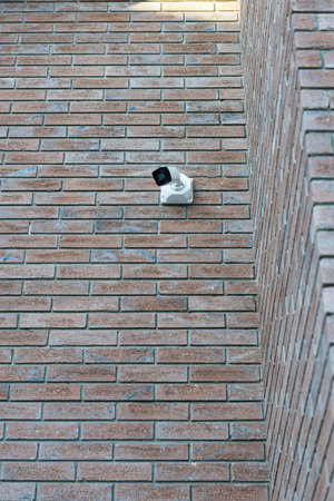 Security camera on the brick wall of the house. Copyspace.の写真素材