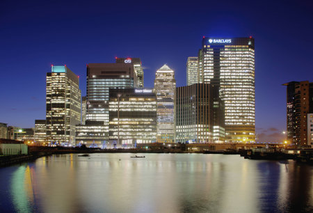 London, UK - February 25, 2014: Night view of the Canary Wharf financial district, viewed from across the Blackwall Basin. Showing some financial buildings and offices lit up against the night sky, including the HSBC and Citibank headquartersのeditorial素材