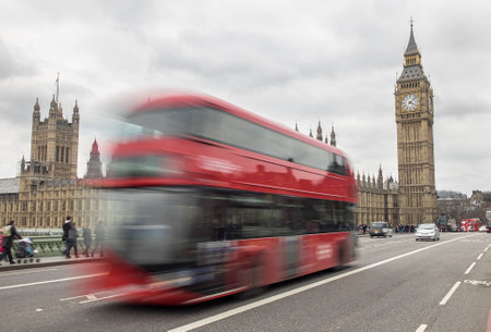 London, UK - April 4:London Bus passing Big Ben on westminster Bridgeの写真素材