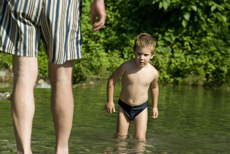 boy meets a river with his fatherの写真素材