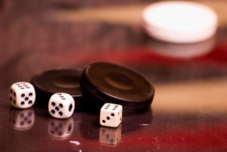 checkers and dice for the game on the board