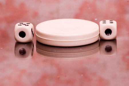 checkers and dice for the game on the boardの写真素材