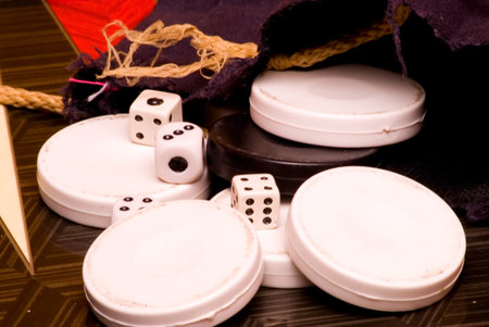 checkers and dice for the game on the board