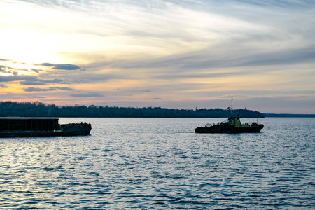 The tug pulls the bargeの写真素材