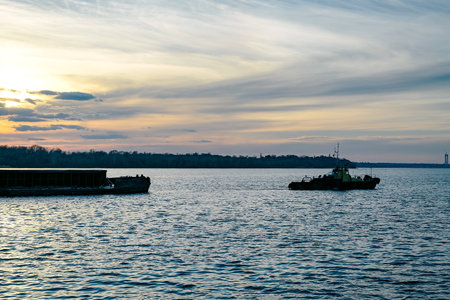 The tug pulls the bargeの写真素材