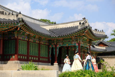 Seoul South Korea - Gyeongbokgung Palace group of vistors wearing traditional costumesのeditorial素材