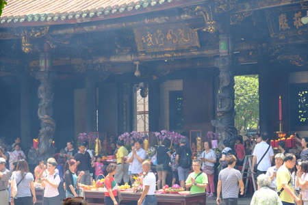 Taipei Taiwan - Lungshan Temple busy scene of buddhist people prayingのeditorial素材