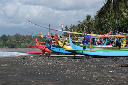 Indonesia Bali Pekutatan - Pantai Medewi - Colorful Outrigger fishing boats Medewi Beachのeditorial素材