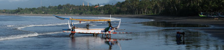 Indonesia Bali Pekutatan - Pantai Medewi - Outrigger fishing boat Medewi Beach panoramaのeditorial素材