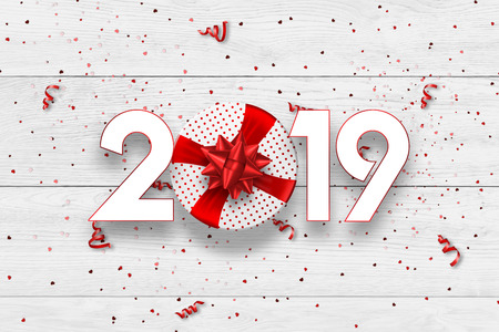 Creative background, numbers 2019 and festive confetti, gift, spiral ribbons on a light background. Happy New Year 2019. Decoration element with tinsel, copy space.の写真素材