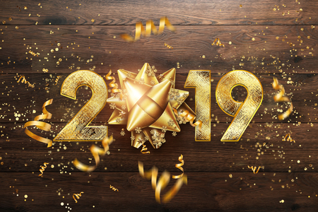 Creative background, 2019 Happy new year. Gold Numbers Design of greeting card of. Gold Shining Pattern. Happy New Year Banner with 2019 Numbers on brown wooden background. Confetti, copy space.の写真素材
