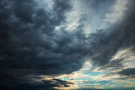 Dark, dramatic clouds, time before a storm, thundery fluffy clouds. Thunderstorm in the city.の写真素材
