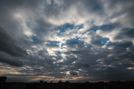 Sun shining through thick cloudy sky, silver liningの写真素材