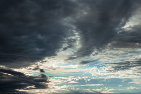Dark, dramatic clouds, time before a storm, thundery fluffy clouds. Thunderstorm in the city.の写真素材