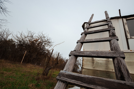 Creative background, wooden staircase leading to the sky. The concept of a career ladder, raising at work, the road to heaven, faith, career growth. Copy space.の写真素材