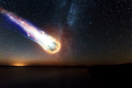 A comet, an asteroid, a meteorite falls to the ground against a starry sky. Attack of the meteorite. Meteor Rain. Kameta tail. End of the world. Astranomy.の写真素材