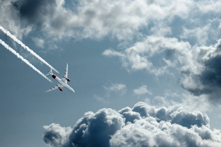 The plane against the blue sky and fluffy clouds. Concept of vacation, vacation, flight, travel.の写真素材