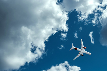The plane against the blue sky and fluffy clouds. Concept of vacation, vacation, flight, travel.の写真素材