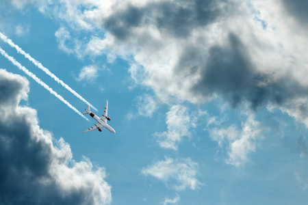 The plane against the blue sky and fluffy clouds. Concept of vacation, vacation, flight, travel.の写真素材