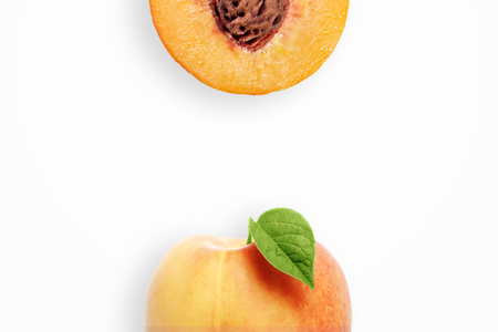 Creative background, peach and slices of peach on a white background. Flat lay, copy space, layout. The concept of nutrition, fresh fruit, natural products, juice.の写真素材