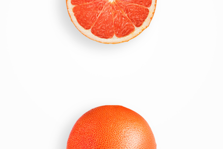 Creative background, grapefruit and slices of grapefruit on a white background. Flat lay, copy space, layout. The concept of nutrition, fresh fruit, natural products, juice.の写真素材