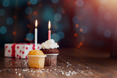 Creative background, cupcake with candles, beautiful bokeh. Happy Birthday. Present. Concept for Holiday Card, Flyer, Background. Copy spaceの写真素材