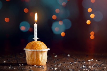 Creative background, cupcake with candles, beautiful bokeh. Happy Birthday. Present. Concept for Holiday Card, Flyer, Background. Copy spaceの写真素材