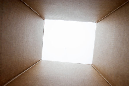 Unboxing, Opened cardboard package from shoot from inside the box. The package, delivery, surprise, gift, lifestyle concept.の写真素材