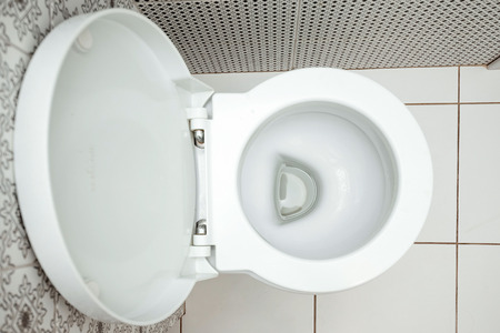 Close-up, White toilet bowl view from above. The concept of cleanliness in the house, hygiene, toilet, microbes.の写真素材