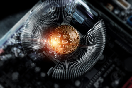 Cryptocurrency, Golden Bitcoin on the computer board. Macro shooting. Concept of cryptocurrency with coins, electronic money, technology. New cryptocurrency, copy space.の写真素材