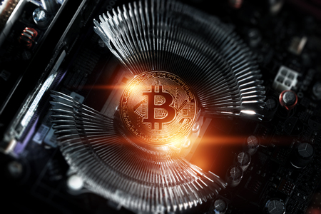 Cryptocurrency, Golden Bitcoin on the computer board. Macro shooting. Concept of cryptocurrency with coins, electronic money, technology. New cryptocurrency, copy space.の写真素材