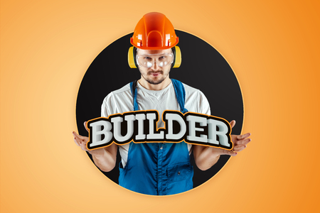 Male builder in orange helmet on an orange background. Concept of construction, contractor, repair.の写真素材