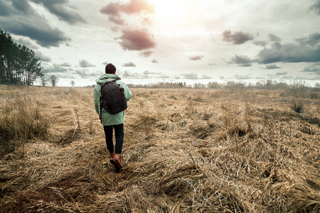 A man with a backpack in nature. Concept traveler, tourist, nature, landscape.の写真素材