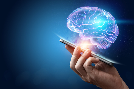The image of the human brain, a hologram, a dark background. The concept of artificial intelligence, neural networks, robotization, machine learning. copy space.の写真素材