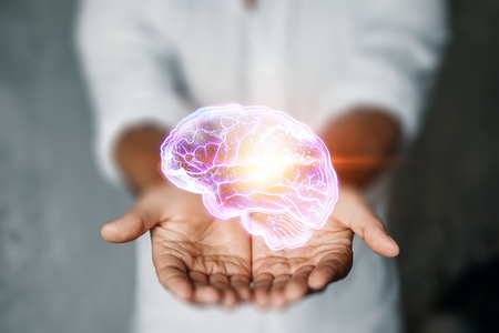 The image of the human brain, a hologram, a dark background. The concept of artificial intelligence, neural networks, robotization, machine learning. copy space.の写真素材