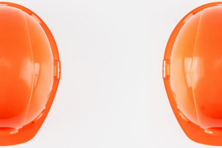 Orange construction helmet on a light background. The concept of architecture, construction, engineering, design. Copy space.の写真素材