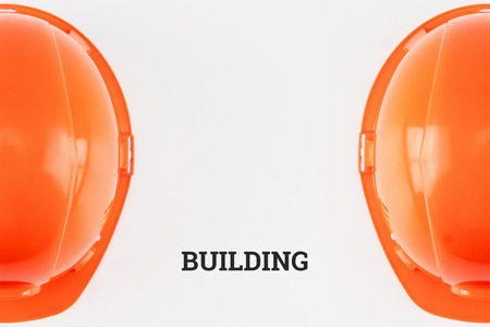 Orange construction helmet on a light background. The concept of architecture, construction, engineering, design. Copy space.の写真素材