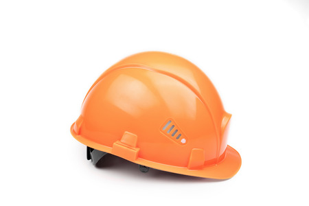 Orange construction helmet on a light background. The concept of architecture, construction, engineering, design. Copy space.の写真素材