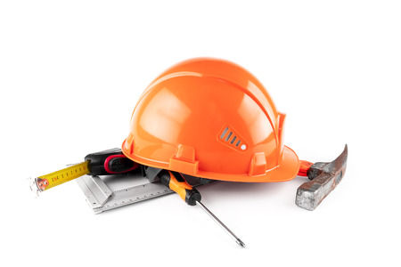 White construction helmet, tape measure, hammer, screwdriver on a light background. Concept architecture, construction, engineering, design, repair. Copy space.の写真素材