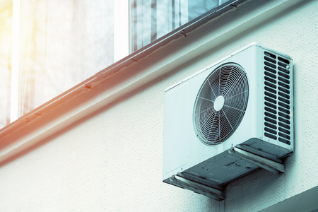 Air conditioning on the wall outside the building. Concept of deterioration of the facade, cold air.の写真素材